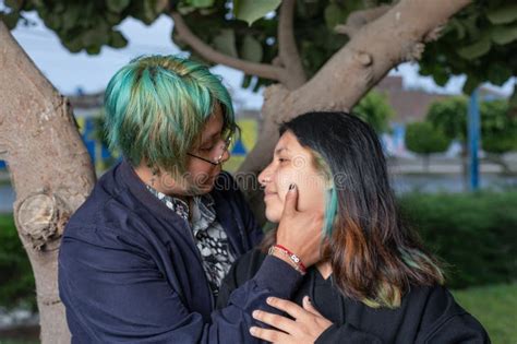 Latin Lesbian Couple Sitting On A Bench In The Park Stock Photo Image