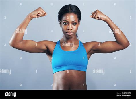 Power Fitness And Portrait Of Black Woman Flexing Arm Muscles For