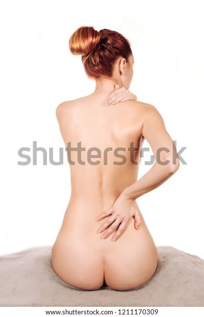 Стоковая фотография 1211170309 Womans Back View Nude Sitting On