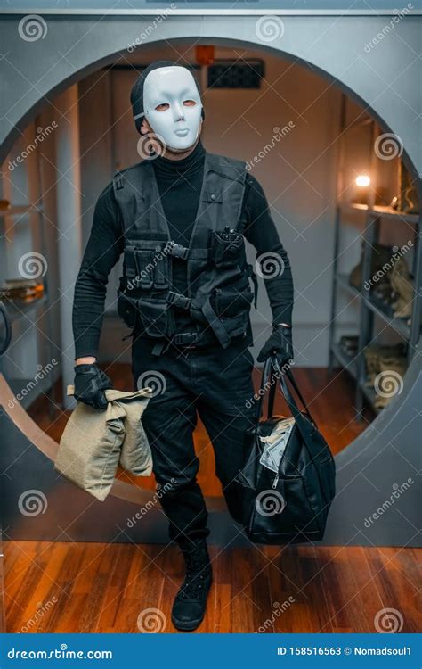 Robber In Black Mask With Shotgun Removing Handcuffs Stock Photo ...