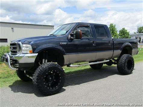 A Large Blue Truck Parked On The Side Of A Road