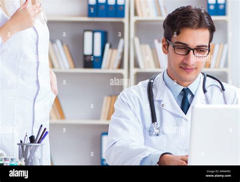 The Male And Female Doctor Having Discussion In Hospital Stock Photo