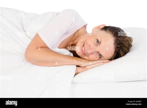 Portrait Of Smiling Mature Woman Lying On Bed Stock Photo Alamy