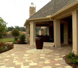 A Brick Walkway Leading To A Large House