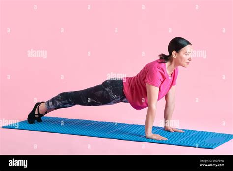 Slim Mature Woman Training Standing In Plank Position Doing Full Body