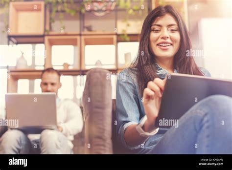 Radiant Brunette Using Digital Computer While Working Next To Colleague Stock Photo Alamy