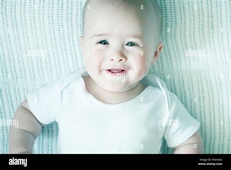 Cute Caucasian Baby Laying On White Blanket Stock Photo Alamy