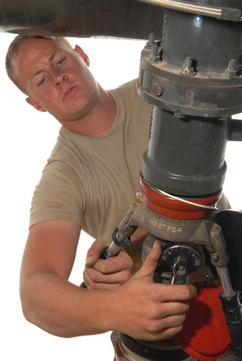 U S Air Force Senior Airman Justin Collins Connects A Pump To Transfer