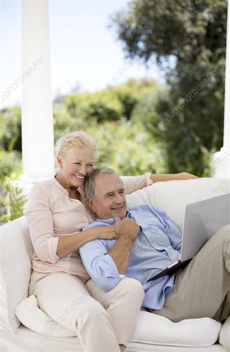 Senior Couple Using Laptop On Patio Sofa Stock Image F014 0805