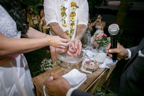 A Group Of People Standing Around A Wooden Table