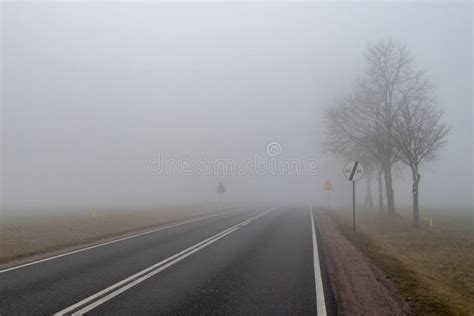 Asphalt Road In A Big Fog Low Visibility On A Busy Road In Central