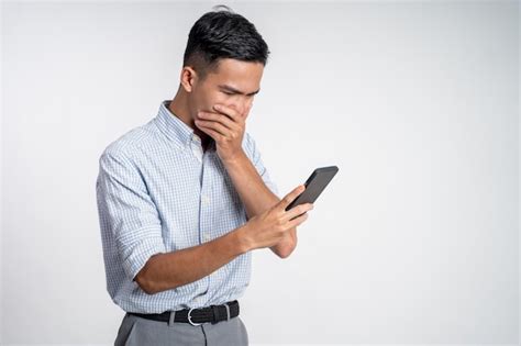 Premium Photo Young Asian Man Shocked While Looking At Smartphone Screen