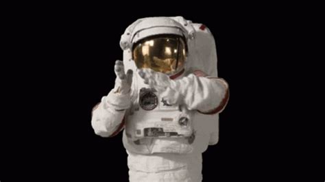 an astronaut in white spacesuit with his hands up to the side, standing ...