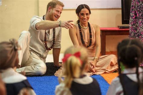 Meghan Markle Beams Alongside Prince Harry As She Waves To Crowd During