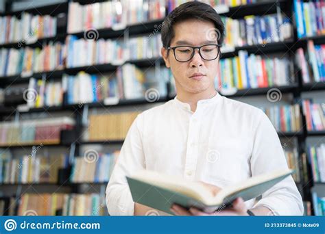 A Man is Reading a Book in the University Library Stock Image - Image ...