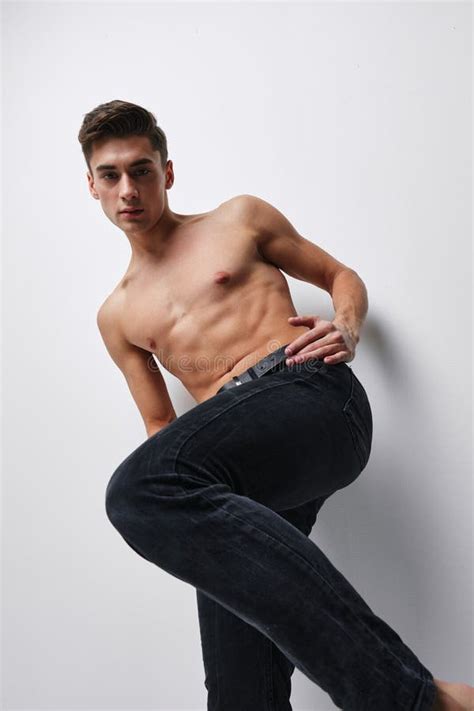 A Man In Trousers With A Raised Leg And A Naked Torso Bottom View Stock Photo Image Of