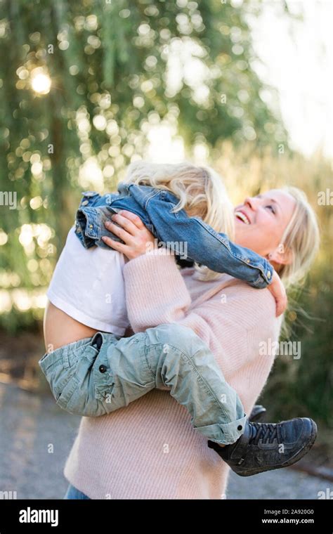 Mother hugging son Stock Photo - Alamy