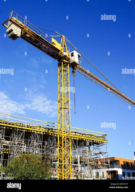 Yellow Construction Tower Crane And Concrete Formwork With A Folding