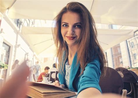 Premium Photo Portrait Of A Young Woman Holding A Smartphone With Her