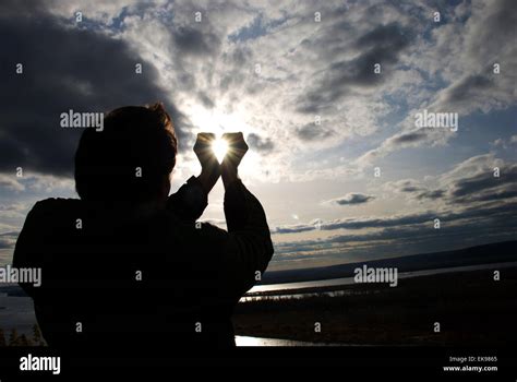 Man Holding A Sun In His Hands Against The Sky Stock Photo Alamy