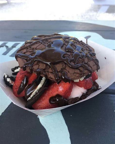 A Chocolate Ice Cream Sandwich With Strawberries In It