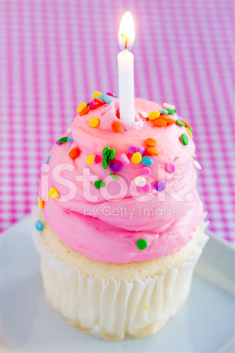 Vanilla Cupcakes With Pink Frosting And Candles Stock Photos