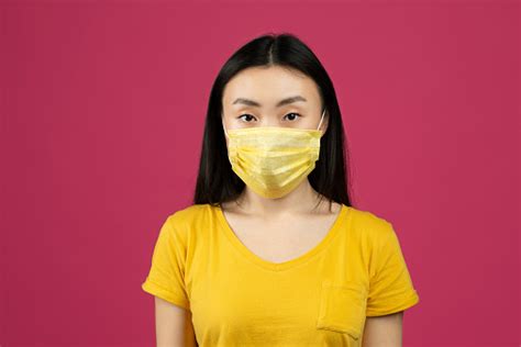 Health Care And Flu Concept Portrait Of Young Chinese Woman Wearing