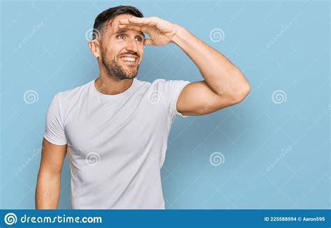 Handsome Man With Beard Wearing Casual White T Shirt Very Happy And Smiling Looking Far Away