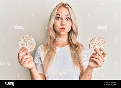 Beautiful Caucasian Blonde Girl Eating Healthy Rice Crackers Puffing