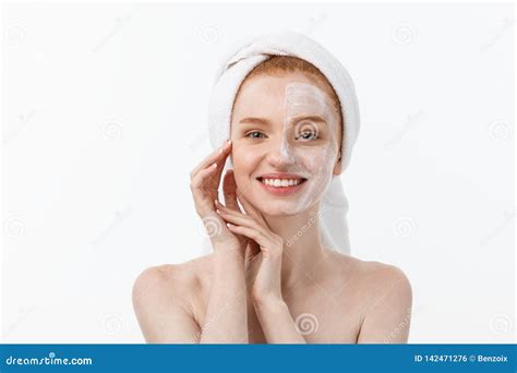 Beautiful Model Applying Cosmetic Cream Treatment On Her Face On White