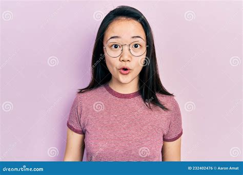 Young Chinese Girl Wearing Casual Clothes And Glasses Afraid And