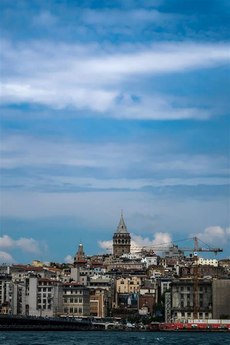 Embankment of river between old buildings in downtown · Free Stock Photo