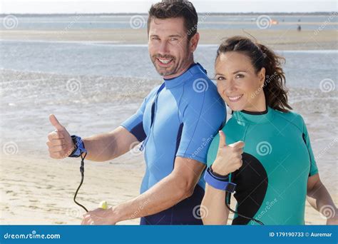 Man Woman Couple Surfboards Surfing On Beach Stock Image Image Of