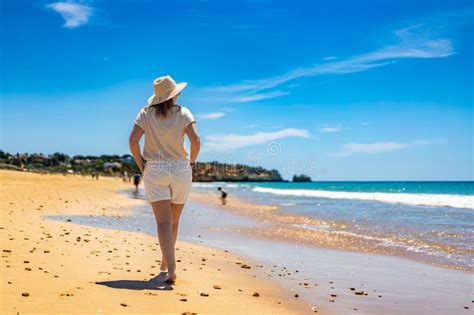 Beautiful Mature Woman Walking On Sandy Beach In Summertime Back View Stock Photo Image Of
