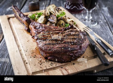 Barbecue Tomahawk Steak On Cutting Board Stock Photo Alamy