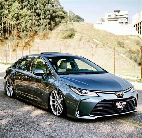 A Gray Car Is Parked On The Side Of The Road