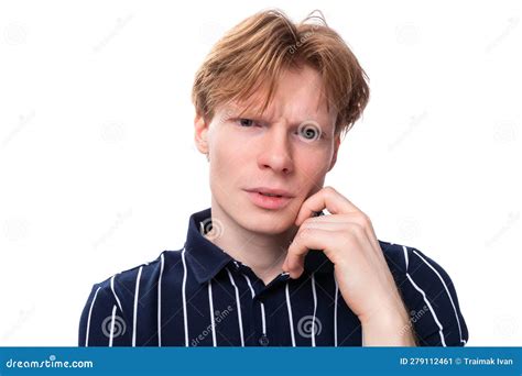 Portrait Of A Well Groomed Young Blond Guy In A Striped Polo Shirt On A White Background Stock