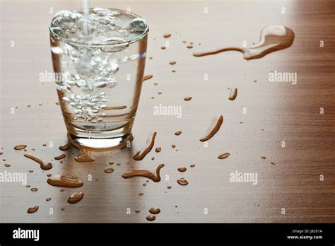 Water Spill Out Of Water Glass And Sloppy On Wood Table Stock Photo Alamy