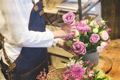 Premium Photo Midsection Of Florist Holding Pink Roses