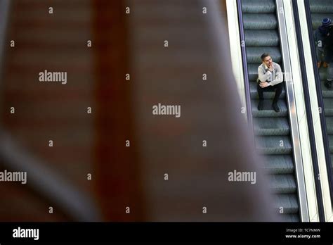 Man Sitting On Escalator Hi Res Stock Photography And Images Alamy