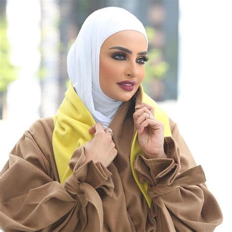 Image May Contain 1 Person Closeup Hijab Outfit Blouse Dress