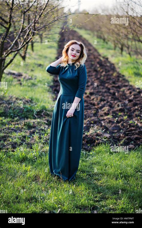 Yong Elegance Blonde Girl At Green Dress On The Garden In Spring Stock