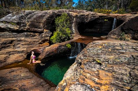 Premium Photo Beautiful Girl In Pink Bikini Sits By Natural Rock Pool