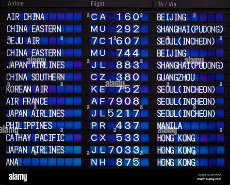 Airport Board Showing Departures And Arrivals To Various Cities Stock