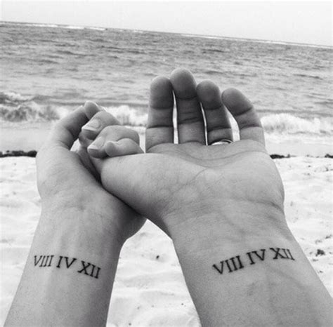 Couple With Roman Numerals Tattoo On The Inside Of Their Wrist