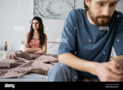 Angry Brunette Woman Crossing Arms While Sitting Near Blurred Boyfriend