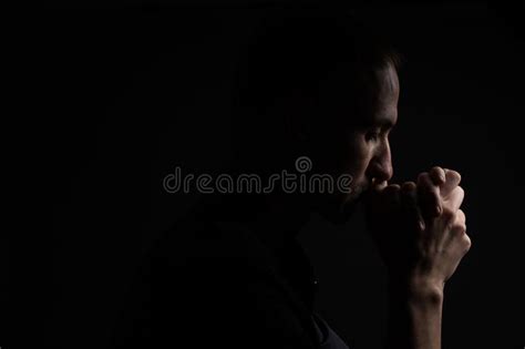 Close Up Of Faithful Mature Man Praying Hands Folded In Worship To God