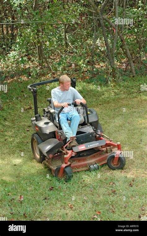 Man Cutting Yard Grass Lawn On Ridding Mower Southern Usa America For A Job Making Money Georgia