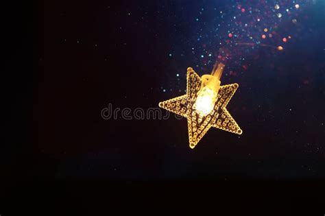 Christmas Warm Gold Garland Lights Over Dark Background With Glitter
