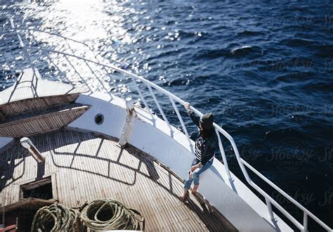 Young Woman Sitting On Ship Deck Looking Away By Stocksy Contributor Ilya Stocksy